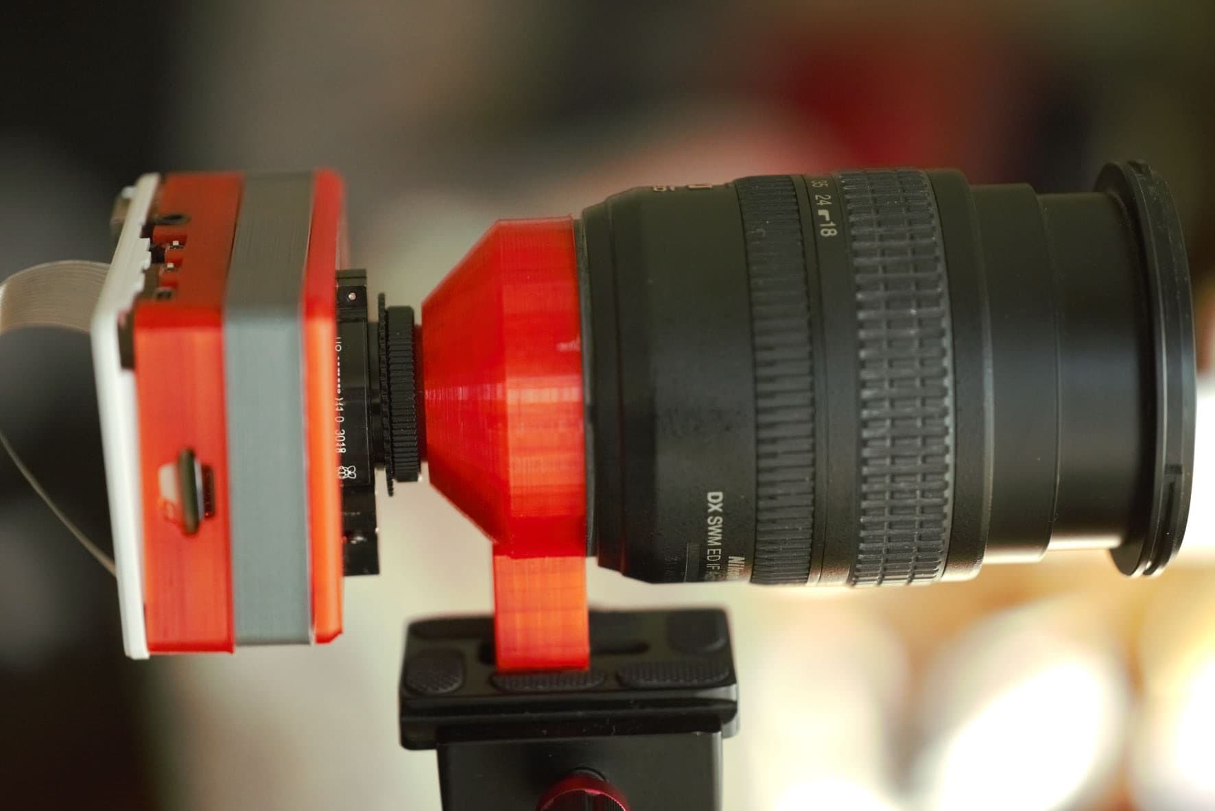 Nikon F to C-mount adapter mounted between a lens and a camera